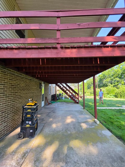 Underside of the original deck framing above the patio before removal — Central Pennsylvania