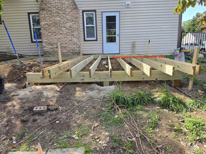 New pressure-treated deck framing and joists set against the house after the old deck was removed — Hampden Township, PA