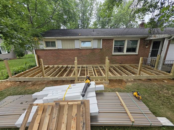Completed joist framing with composite decking bundles staged nearby — Richland, PA
