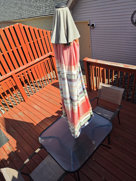 Old wood deck boards and railing with patio furniture before the refresh, Upper Allen Township, PA