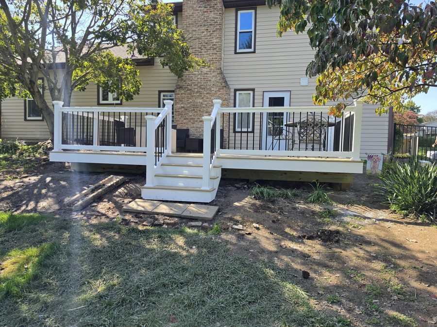 Finished composite deck with white vinyl railing, black balusters and new stairs on the back of a home in Hampden Township, PA