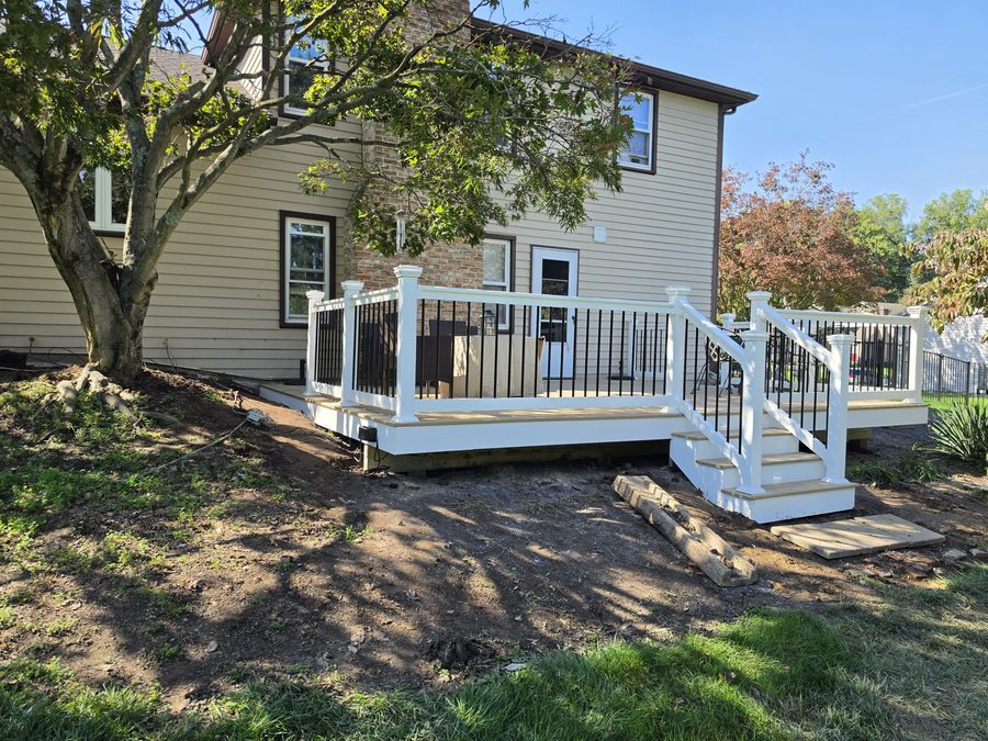 New deck and stair run with white vinyl railing viewed from the side yard — Hampden Township, PA
