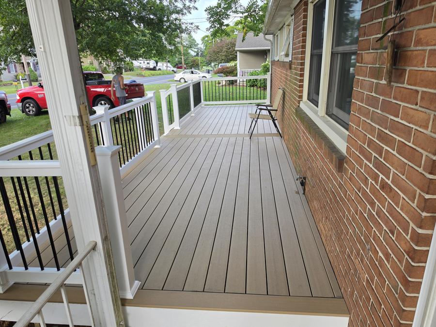 Composite decking surface and white vinyl railing viewed along the length of the finished deck in Richland, PA