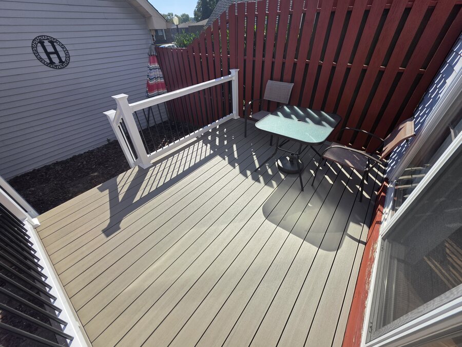 New Weather Oak composite decking and white vinyl railing beside the patio door and privacy fence, Upper Allen Township, PA